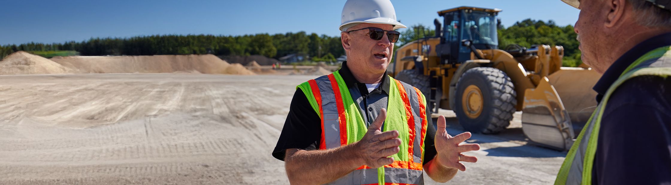 Two people talking on jobsite