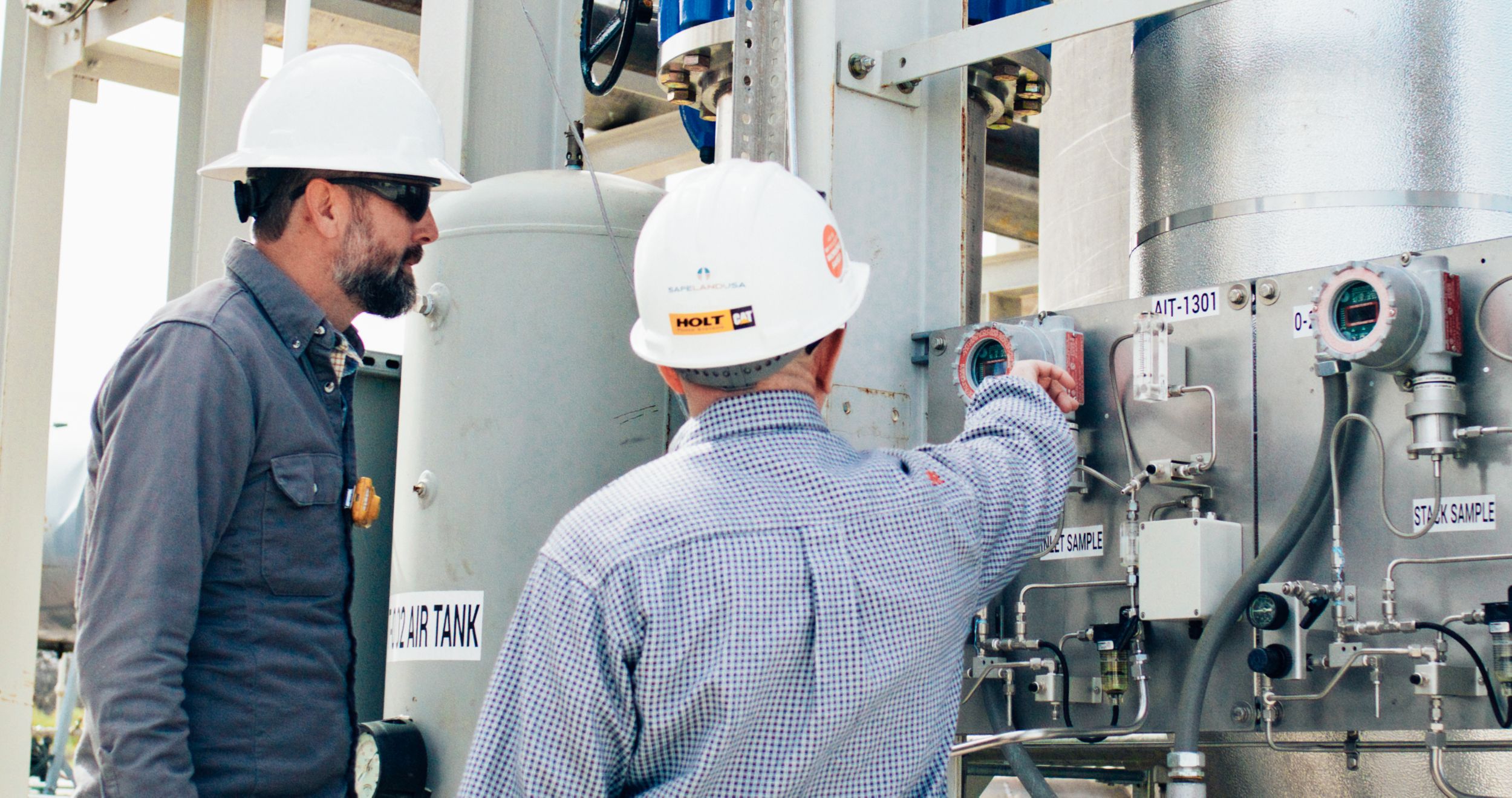 Two employees working in the field