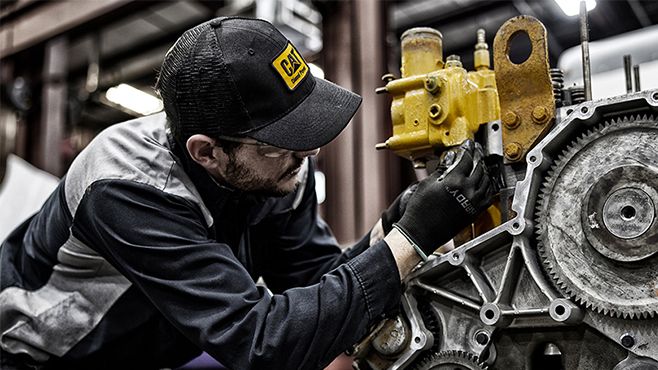 Man servicing Cat Truck Engine