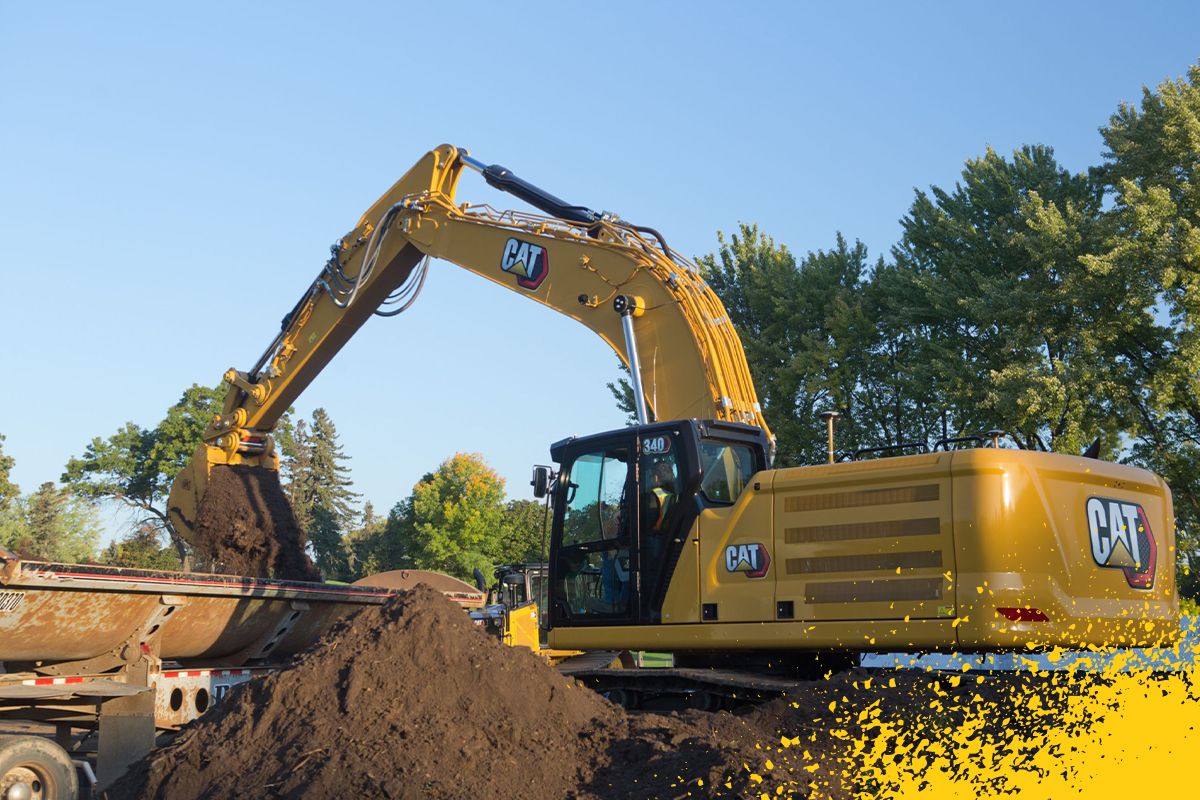 grande escavadeira descarregando sujeira no caminhão