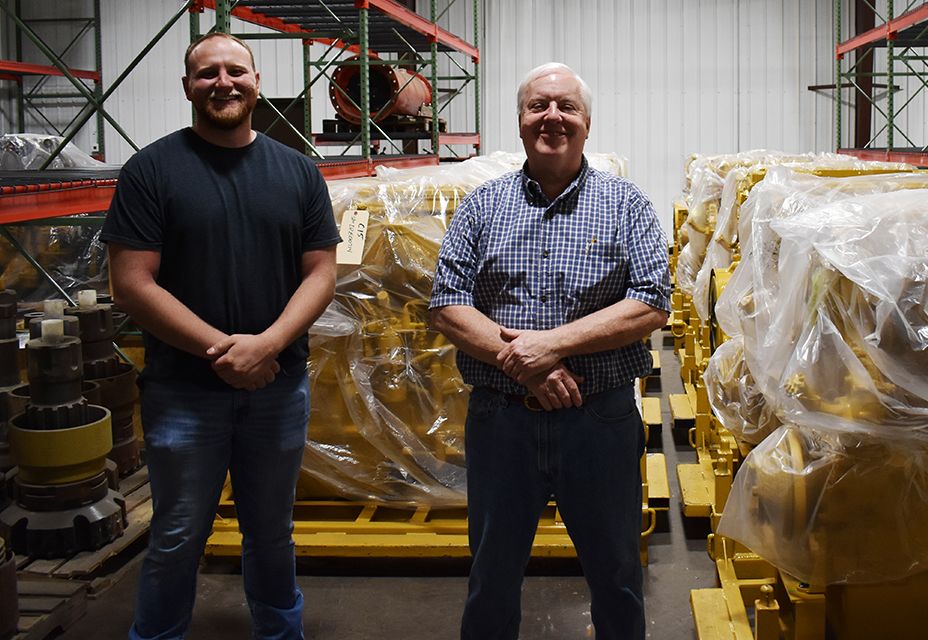 Josh Pierce, sales and engineering support, and Carl Foust, chief engineer, stand beside Cat engines, ready for installation.