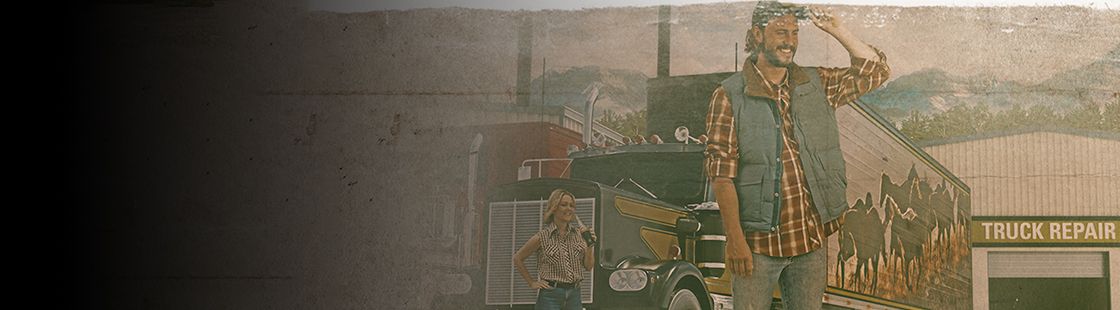 two people celebrating a successful truck engine repair