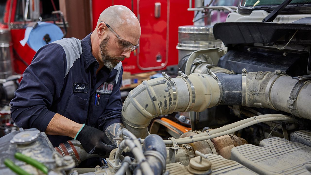 mechanic working on a cat truck engine