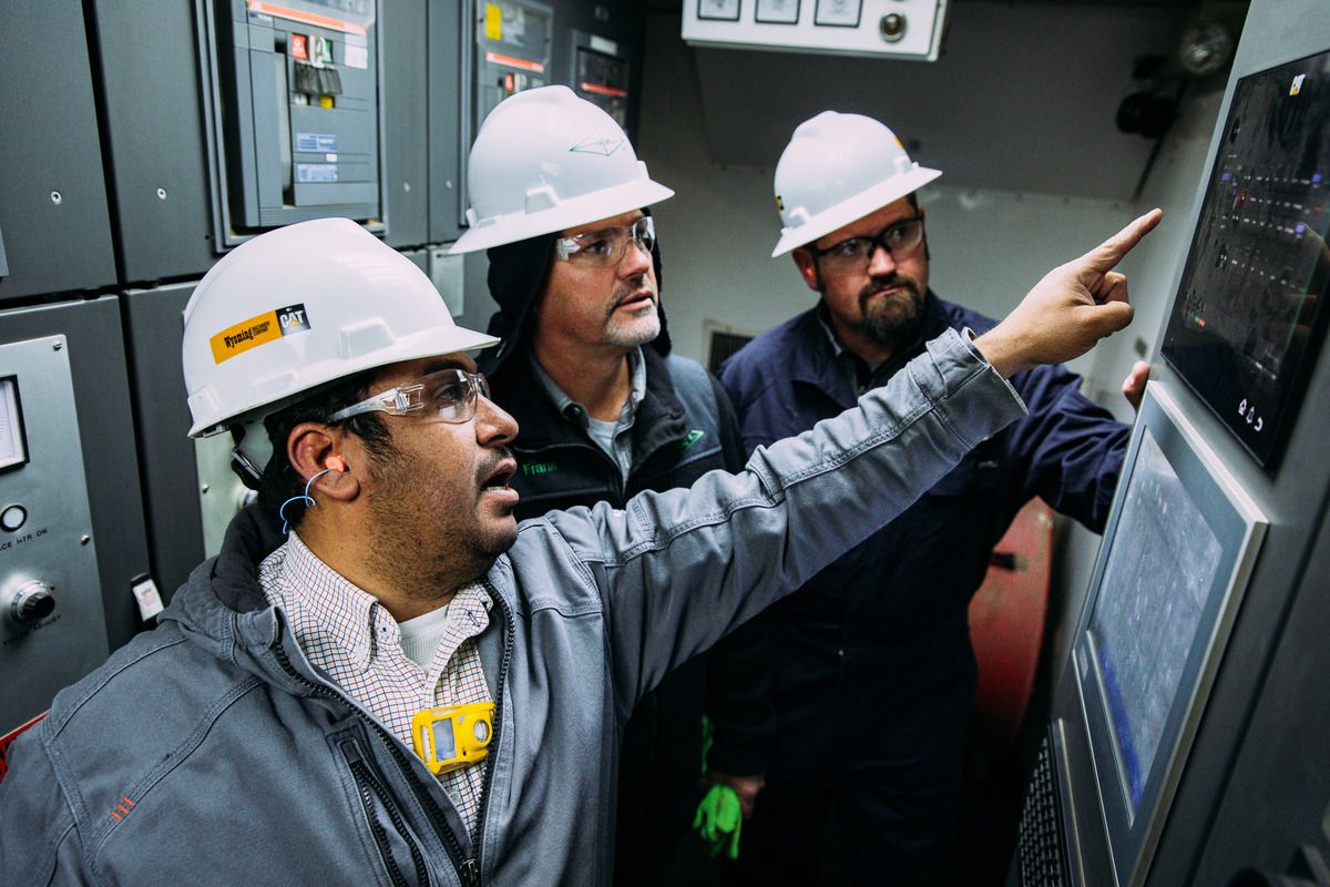 Alfonso with two other Caterpillar employees