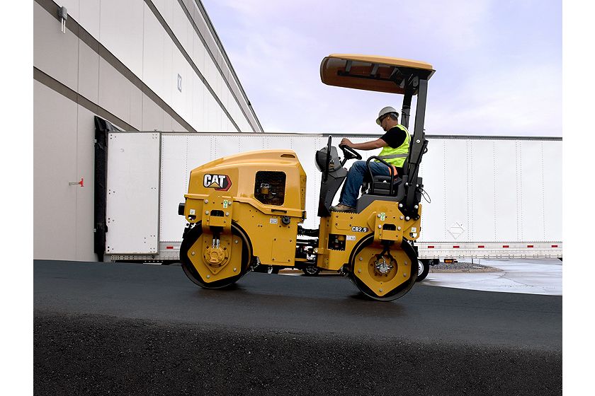 CB2.9 tandem vibratory roller compacting asphalt in a parking lot.