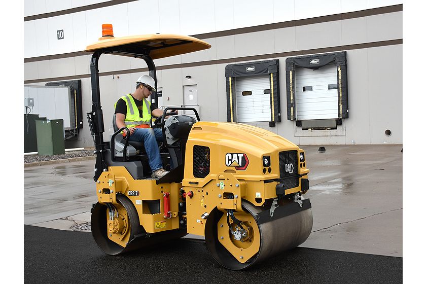 CB2.7 tandem vibratory roller compacting asphalt in a parking lot.