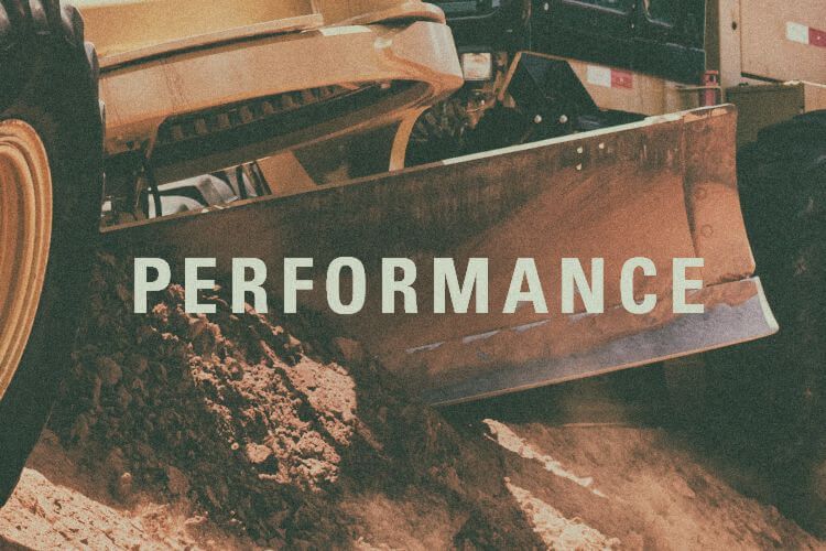 Closeup of motor grader blade with "Performance" graphic