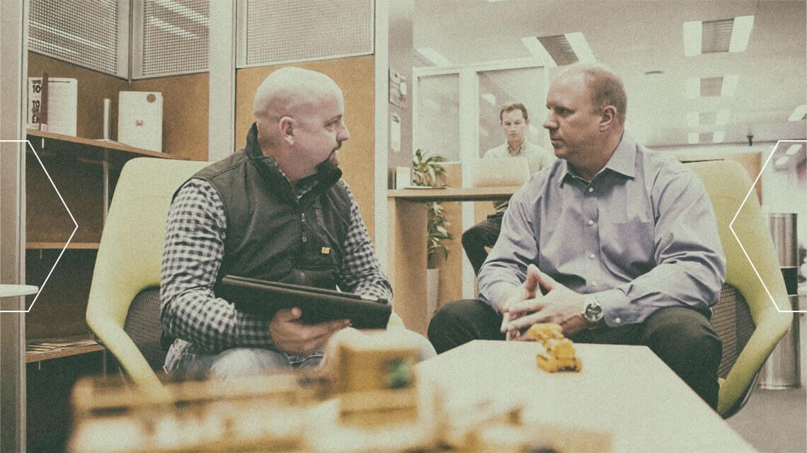 Two people talking in an office setting