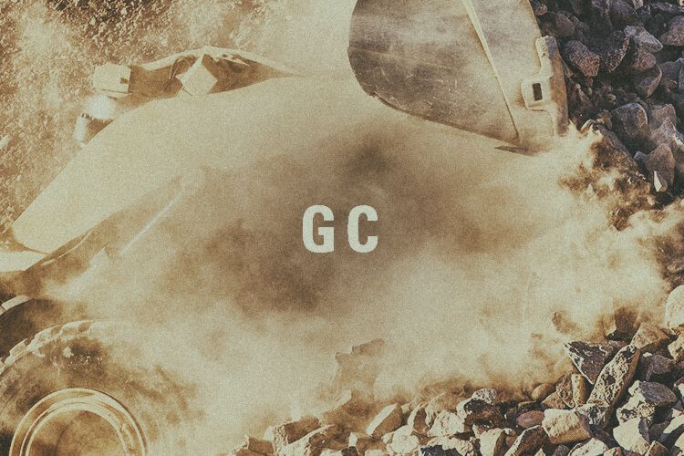 Closeup of wheel loader bucket with "GC" graphic