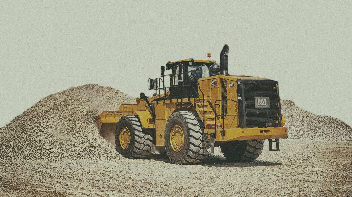 Medium wheel loader scooping material