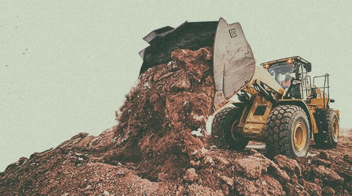 Wheel loader lifting up dirt