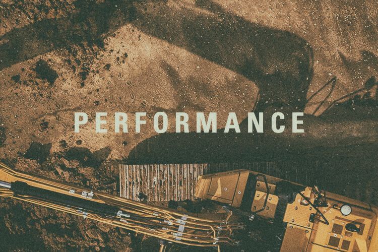 Aerial view of excavator with "Performance" graphic