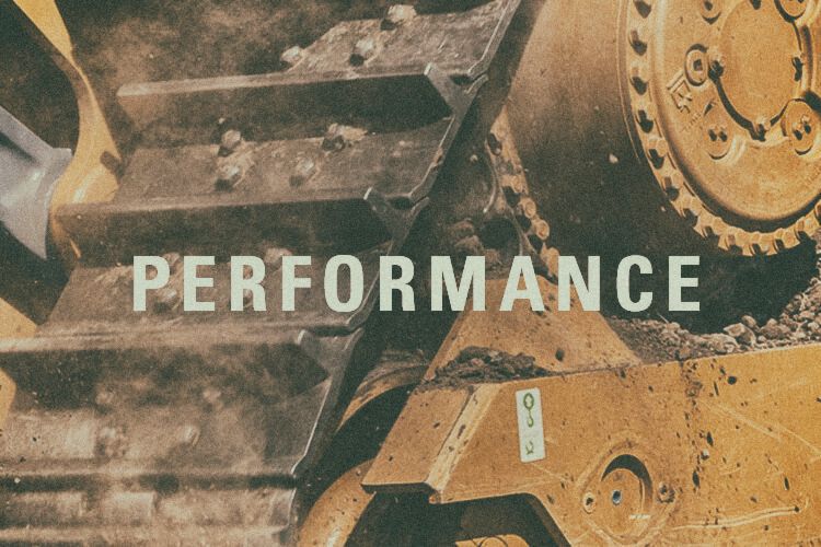 Closeup of dozer tread with "Performance" text graphic
