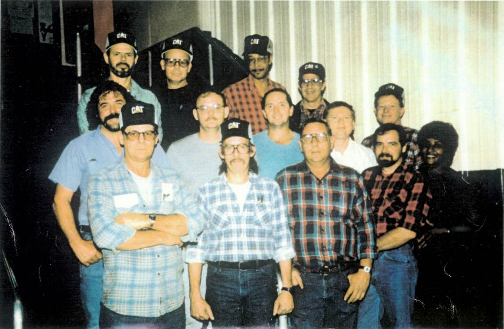 Group of manufacturing employees posing for a team picture