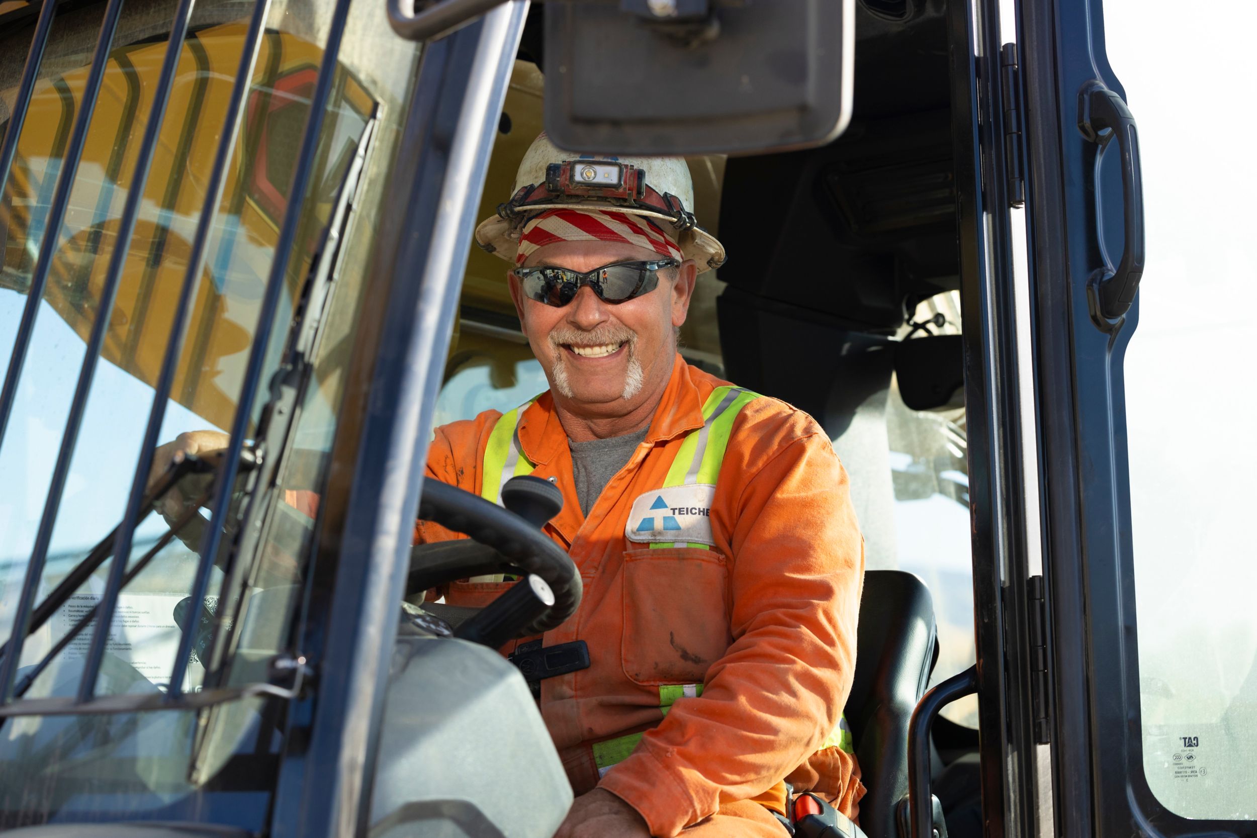 Man smiling in machine cab