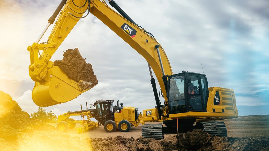330 Excavator and Motor Grader on a Jobsite