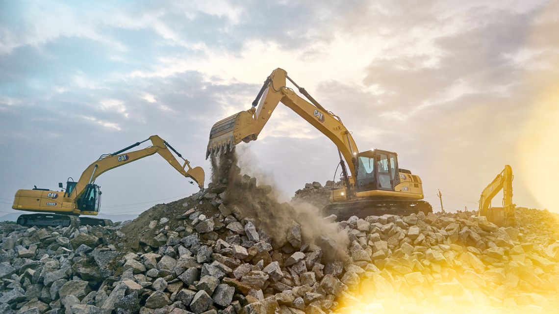 Excavators digging rocks on a jobsite