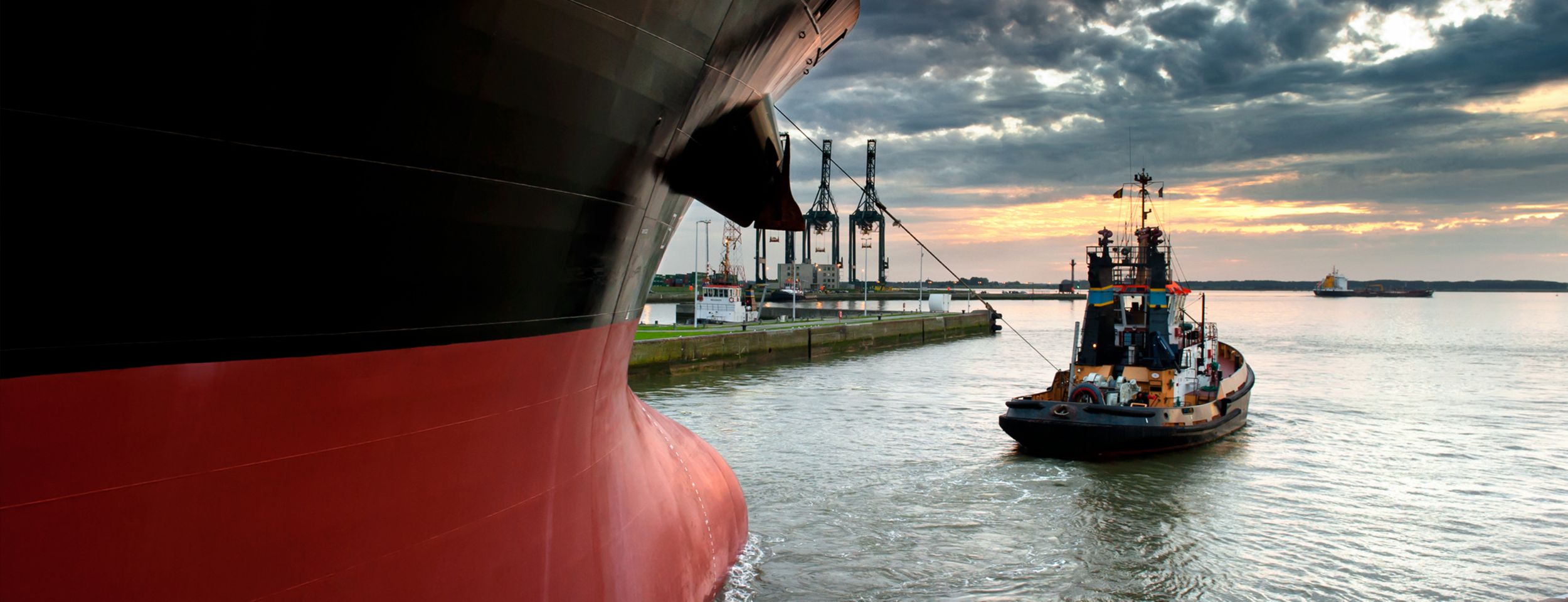Tugboat taking a ship out of harbor