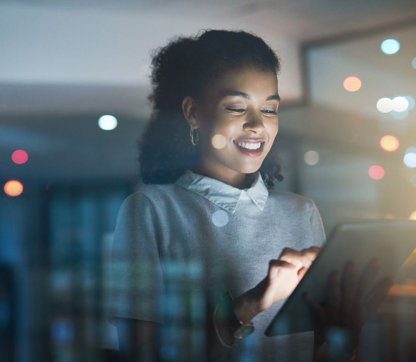Woman reading ipad at night