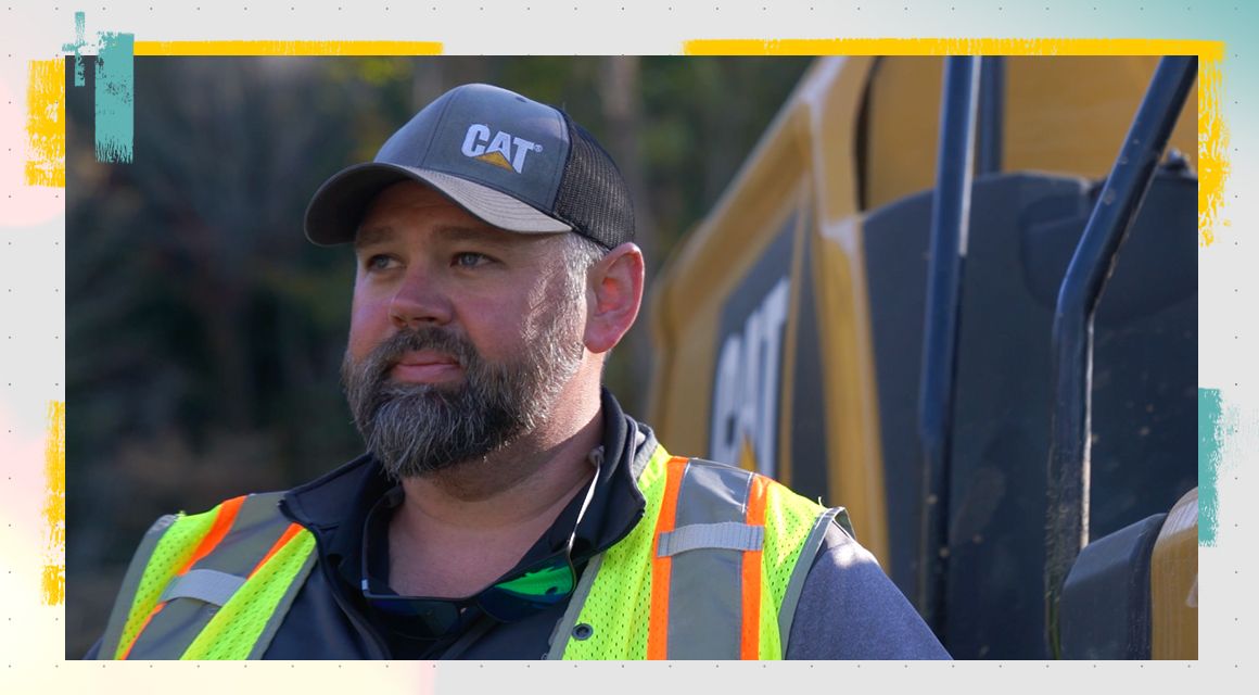 Portrait of a man in front of a Cat machine