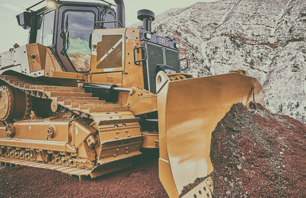 D6 Dozer pushing dirt with Colorado mountains in the background