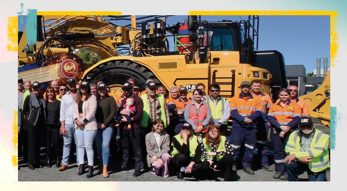 QH&M Birt employees in front of a Cat machine