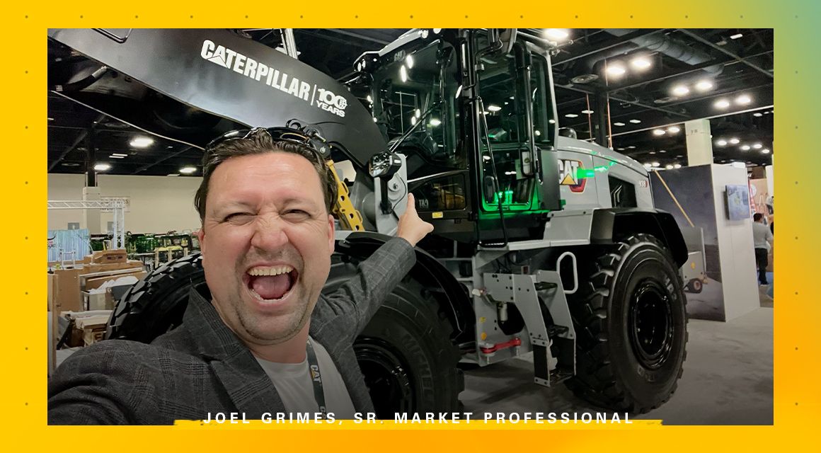 Joel Grimes, Sr. Market Professional in front of a Centennial Grey machine