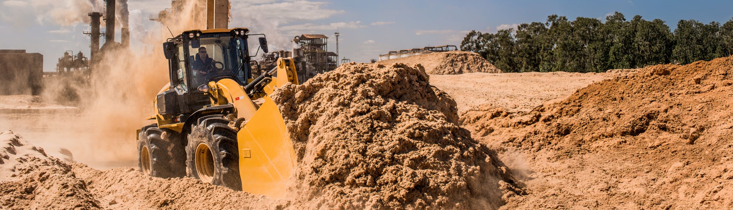 Small Wheel Loader 938 pushing mound of dirt