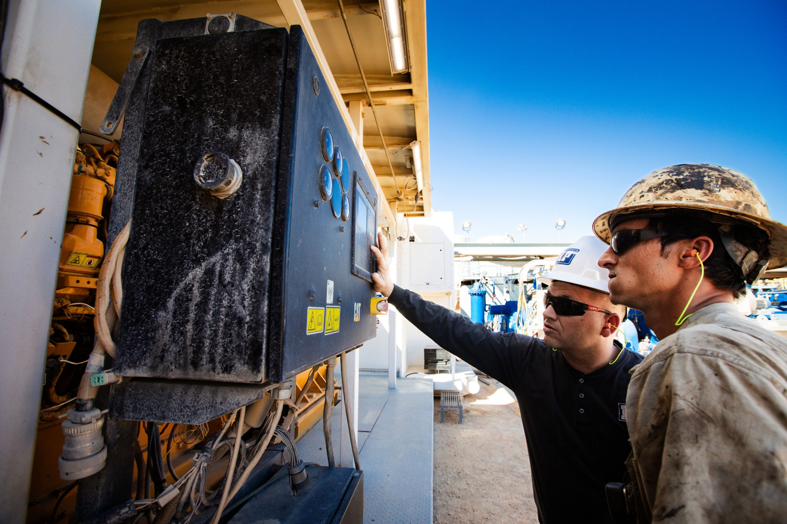 Technicians programming a engine panel