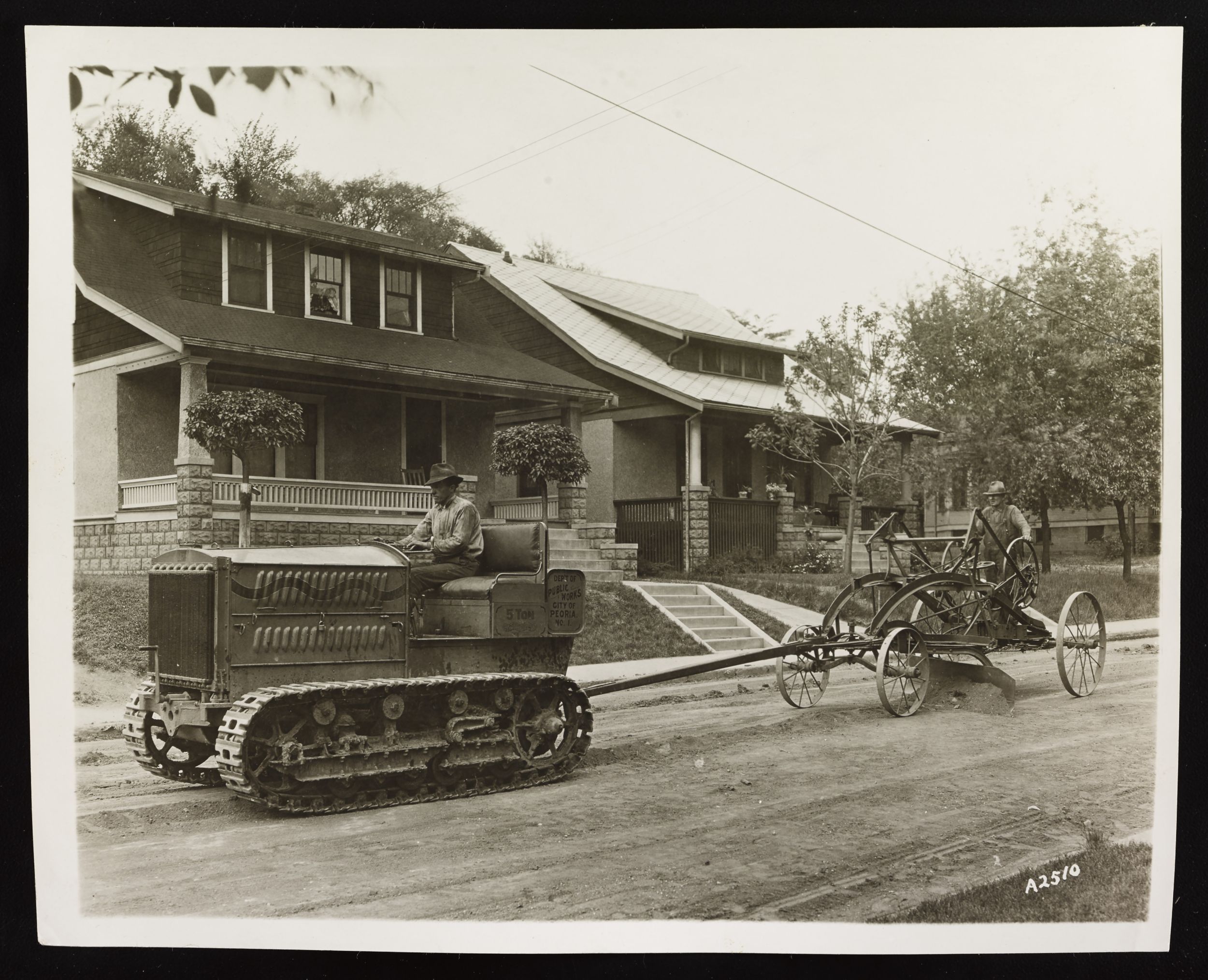 Holt 5-Ton Track-Type Tractor grading a road in a subdivision in Peoria, Illinois, ca. 1923.