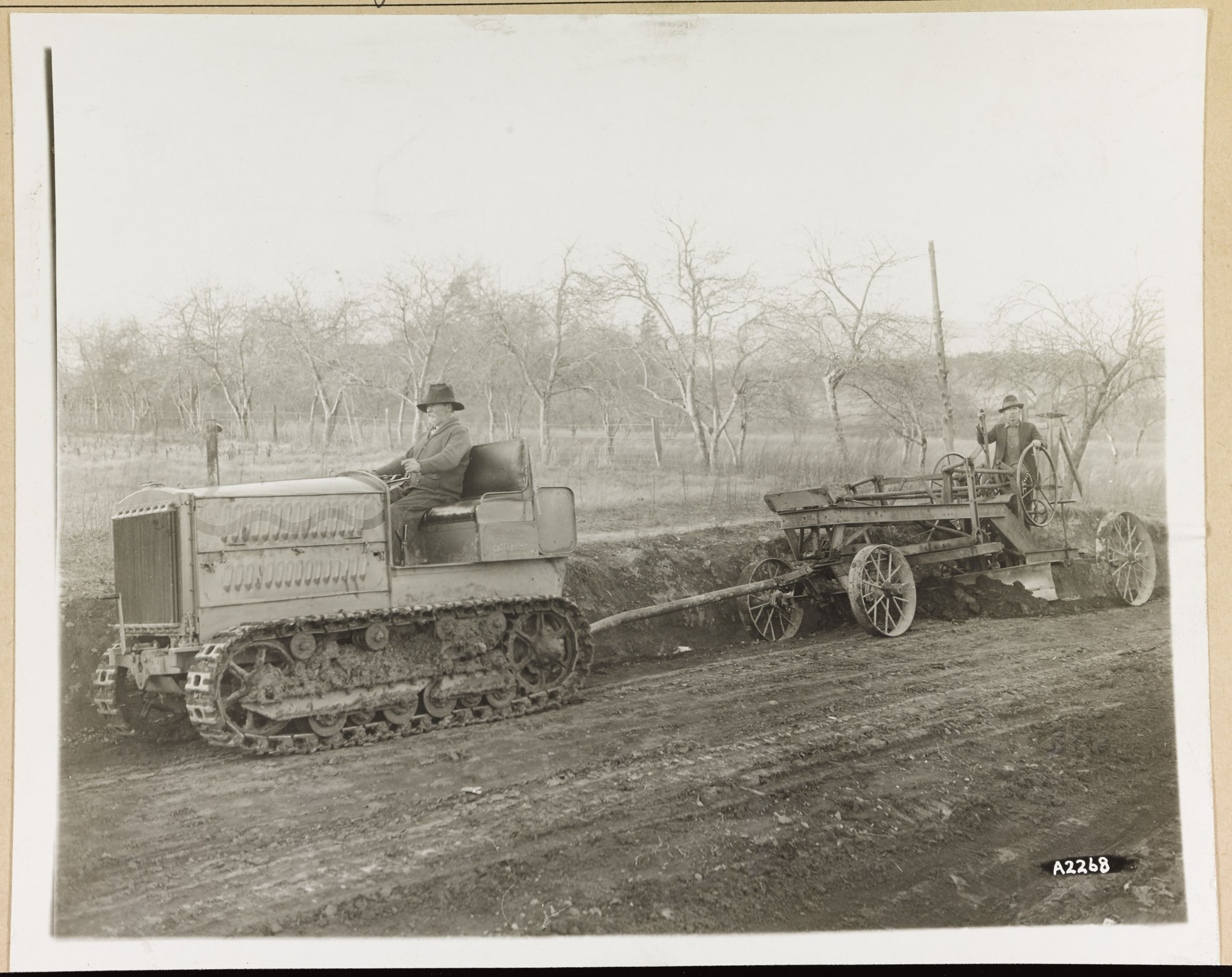 Holt 5-Ton Track-Type Tractor pulling a grader, ca. 1923.