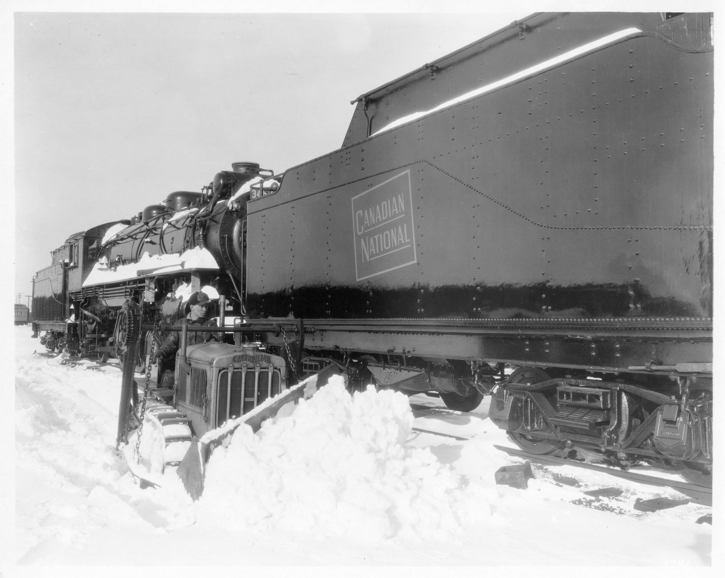 Caterpillar Ten Track-Type Tractor clearing snow beside railroad tracks in Montreal, Canada, 1932.