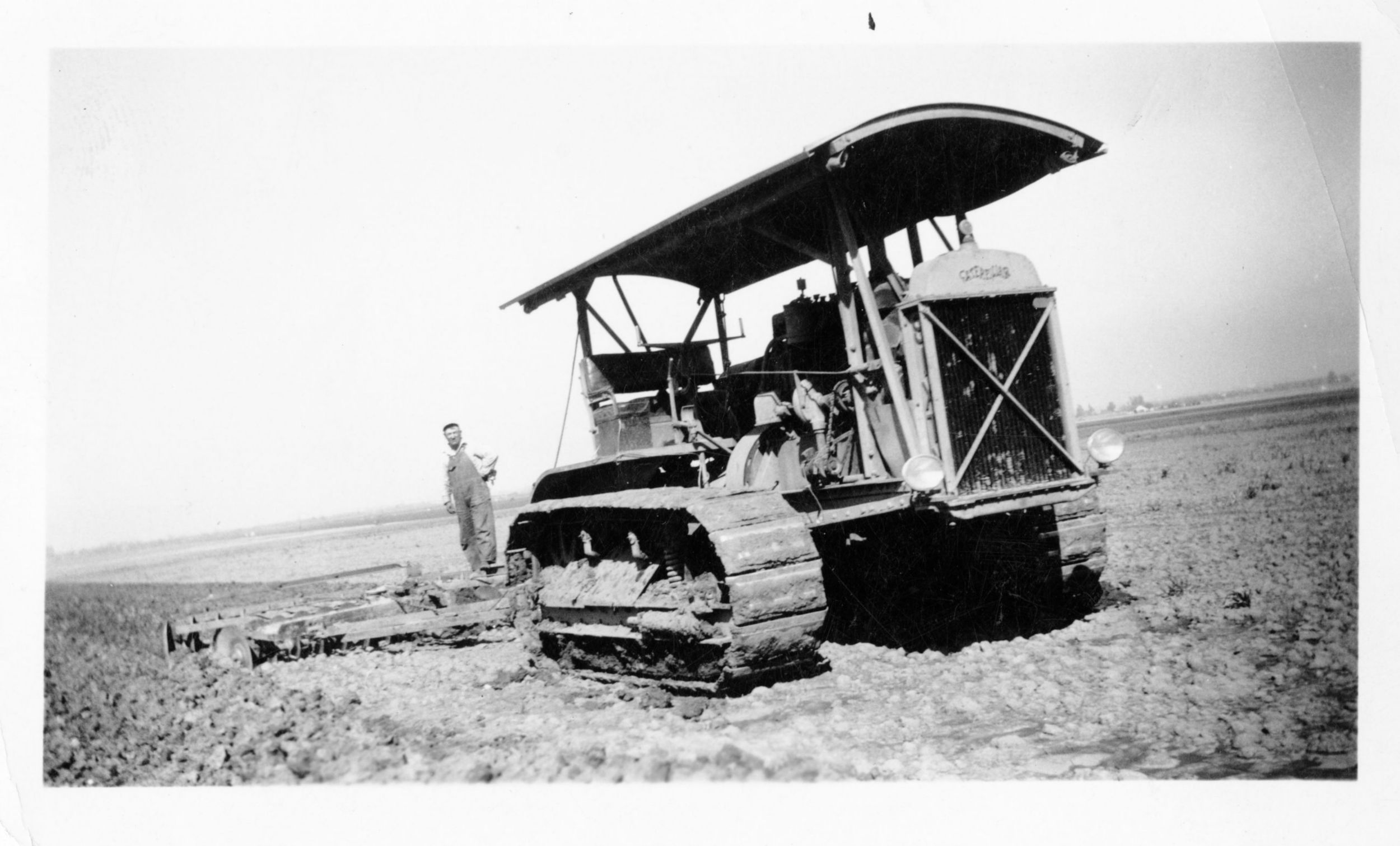 Art Gisler plowing on the family farm using a Caterpillar Sixty Track-Type Tractor, ca. 1935.