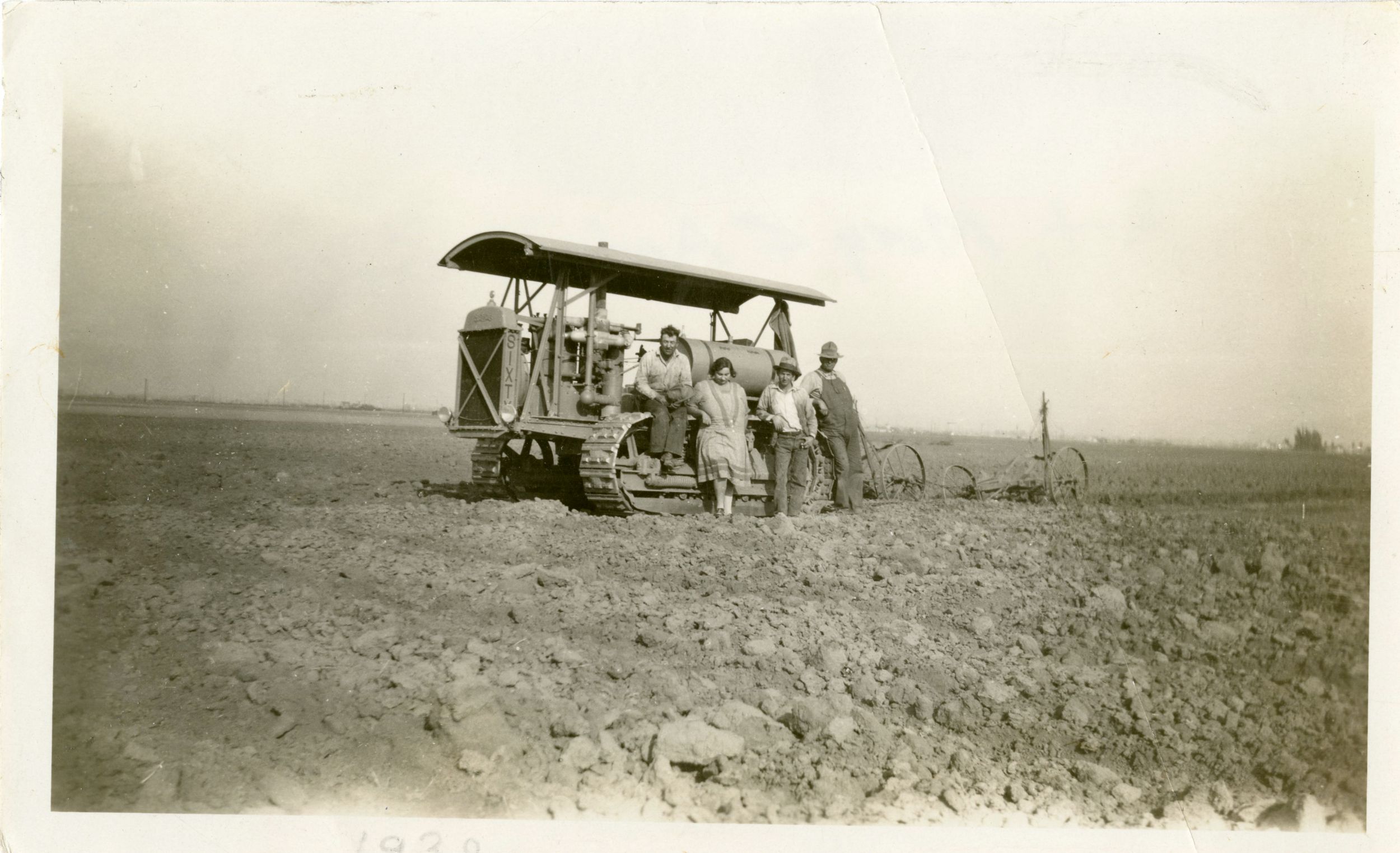 Art, Mary, and Antone Gisler pose on the family farm with their Caterpillar Sixty Track-Type Tractor, 1930.
