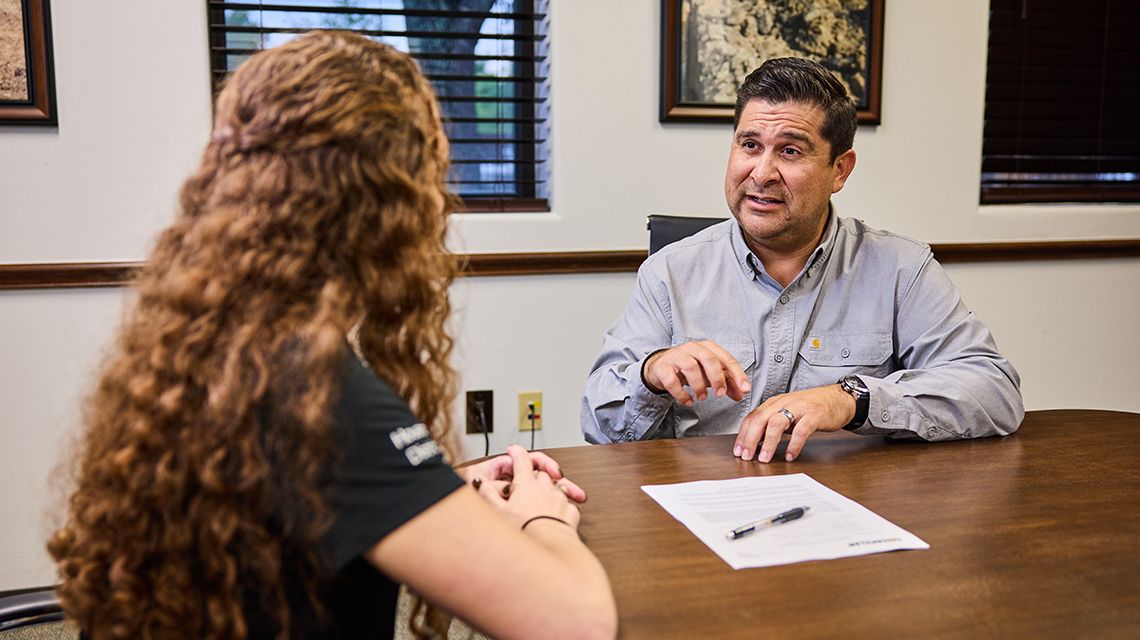 two people discussing a deal