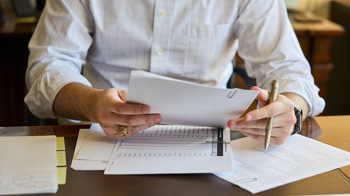 person filling out some documents at a desk
