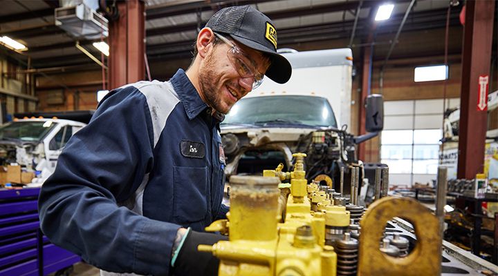 mechanic wearing gloves while inspecting an engine