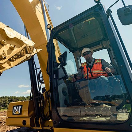 Worker inside excavator cab