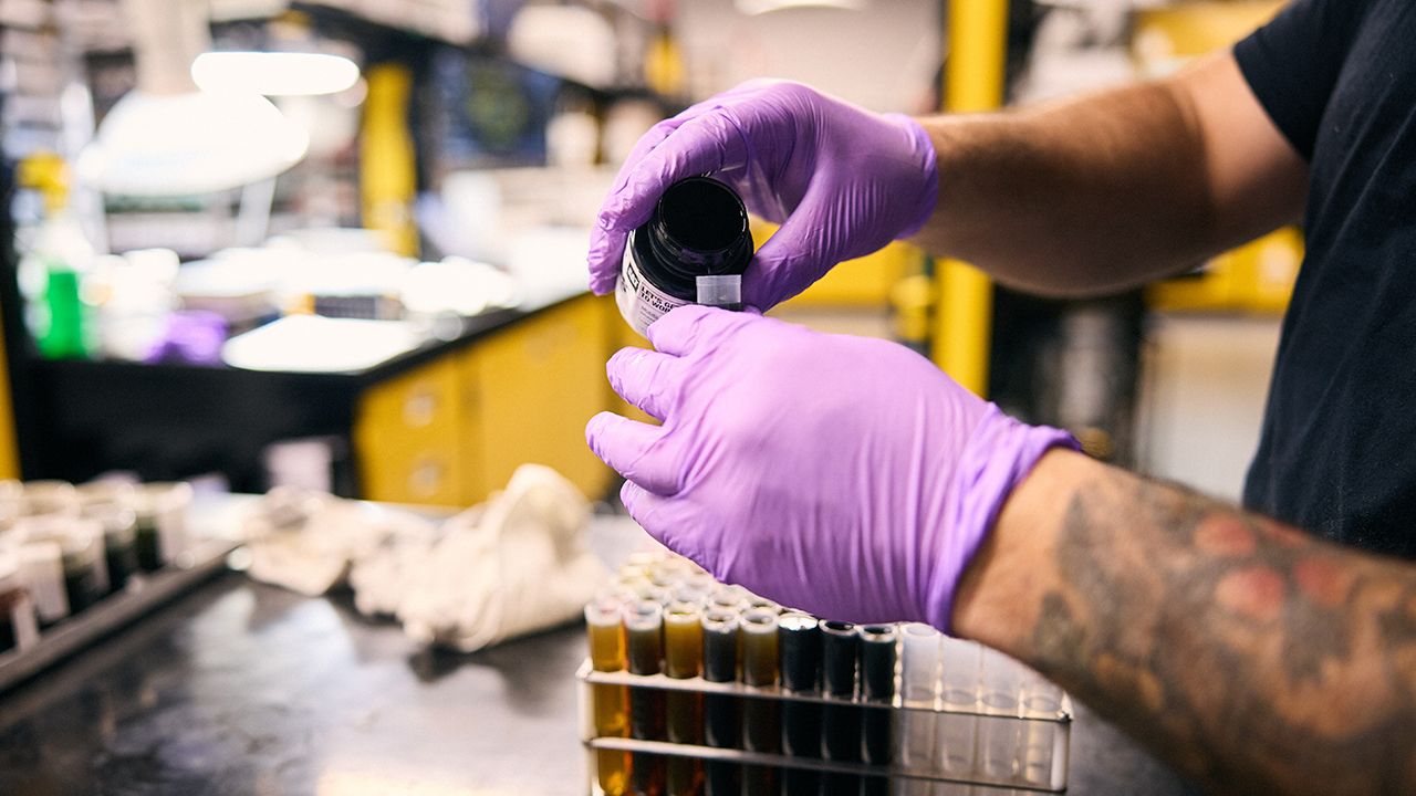 pouring fluid into a vial for testing