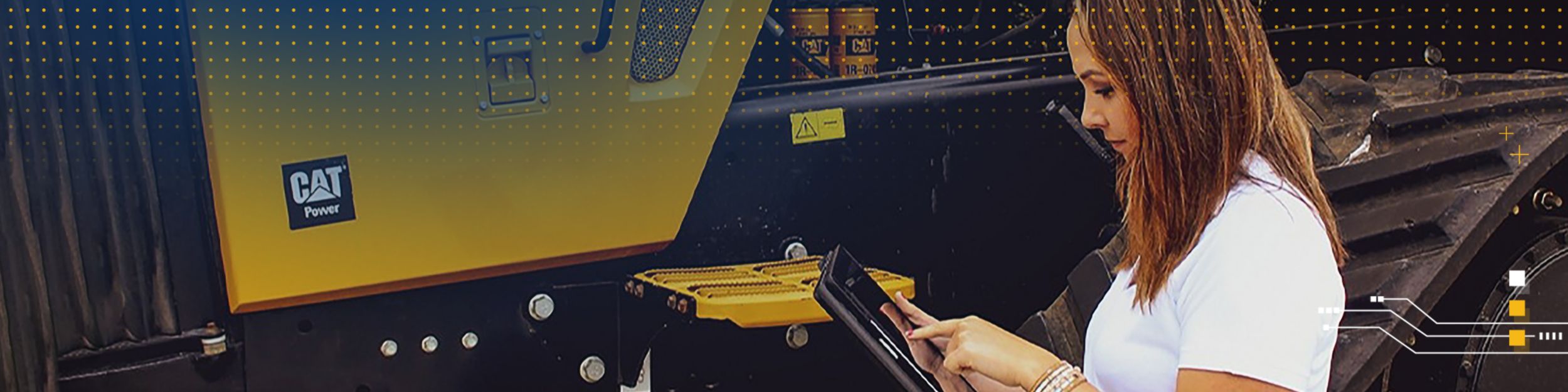 Woman in front of Cat equipment using a tablet