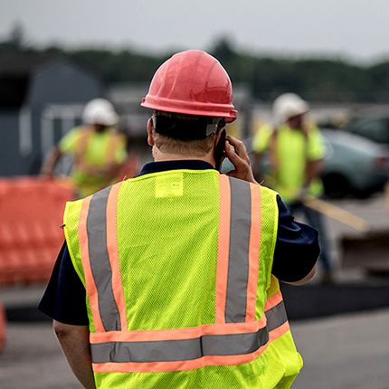 Operator talking on cell phone at job site