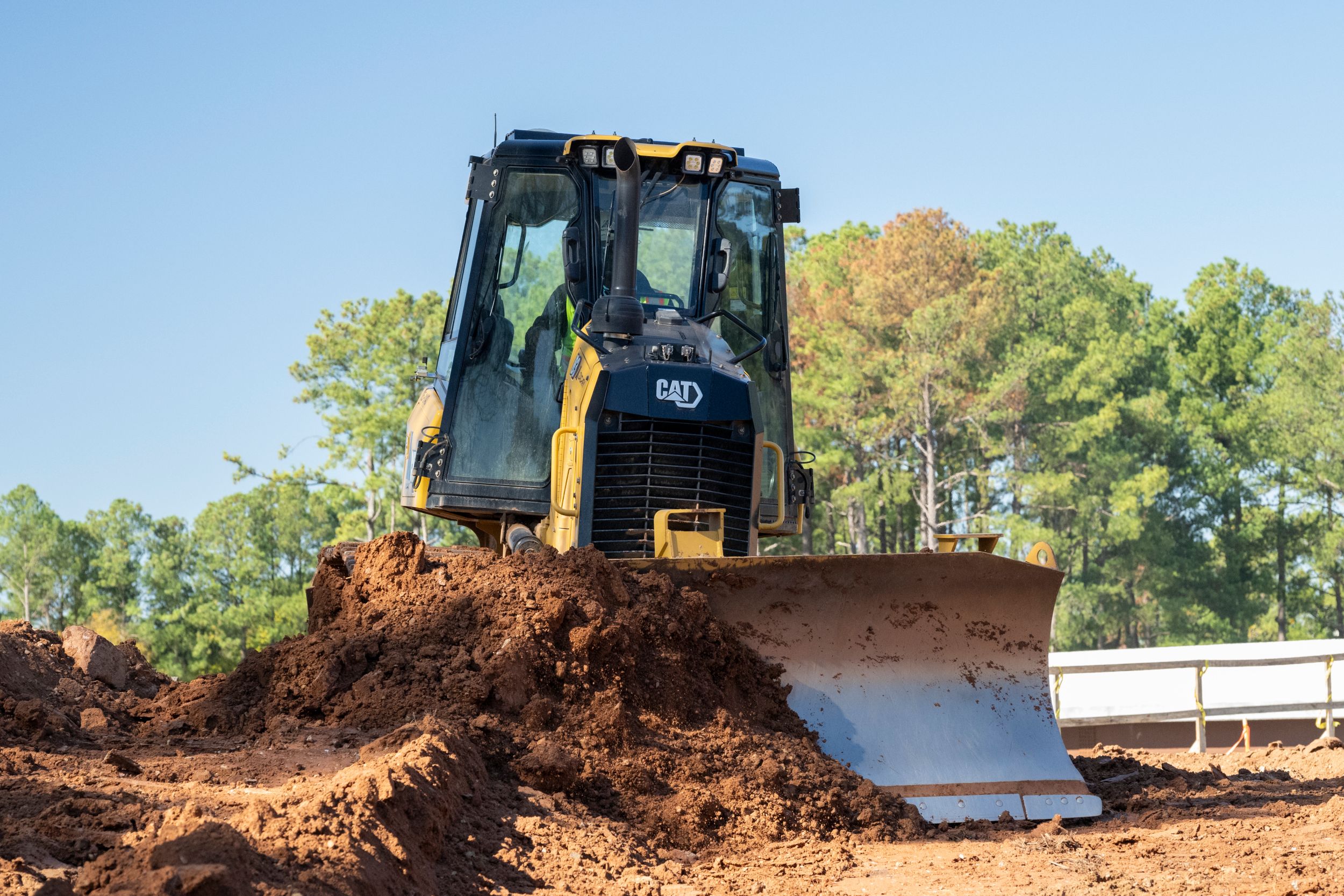 Cat dozer pushing dirt on a worksite