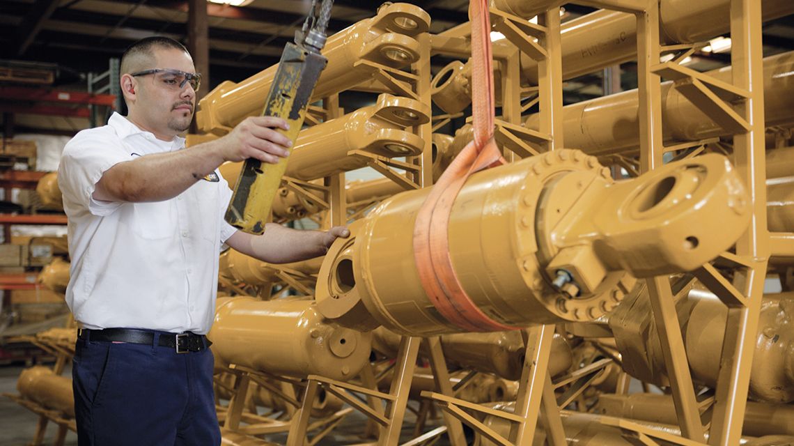 person holding a cylinder, ready to install or replace