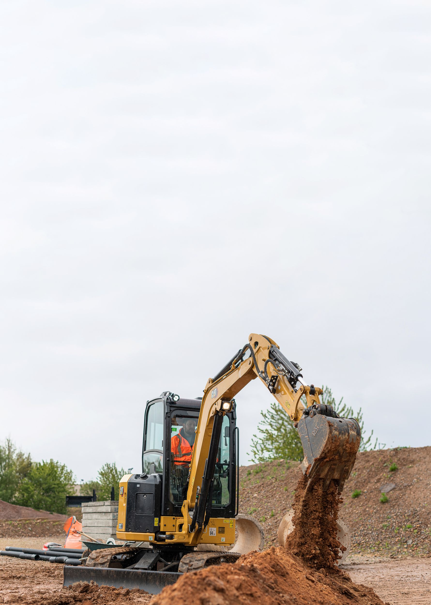 Cat Excavator dumping dirt