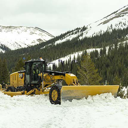 Motor grader plowing snow