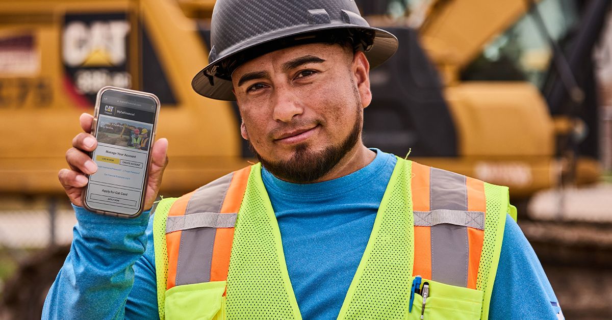 Cat employees talking in front of heavy haul truck