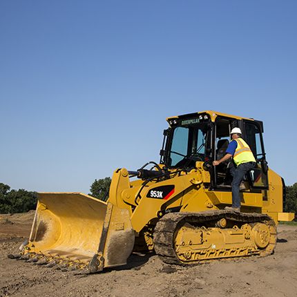 man climbing loader steps