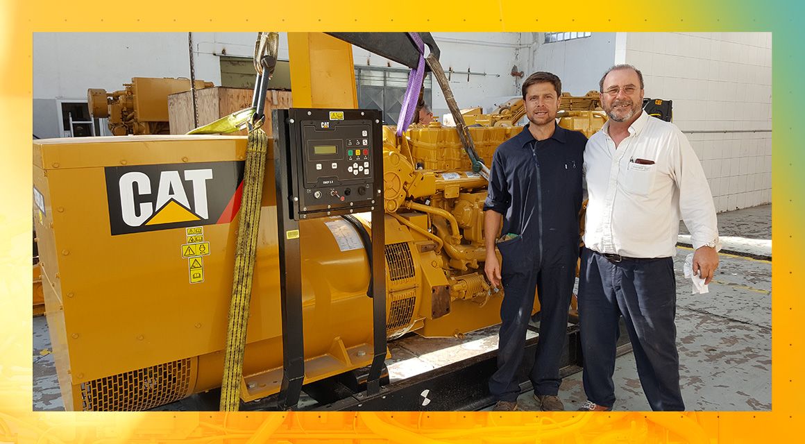 Two Men Standing in Front of Cat Electric Power Equipment
