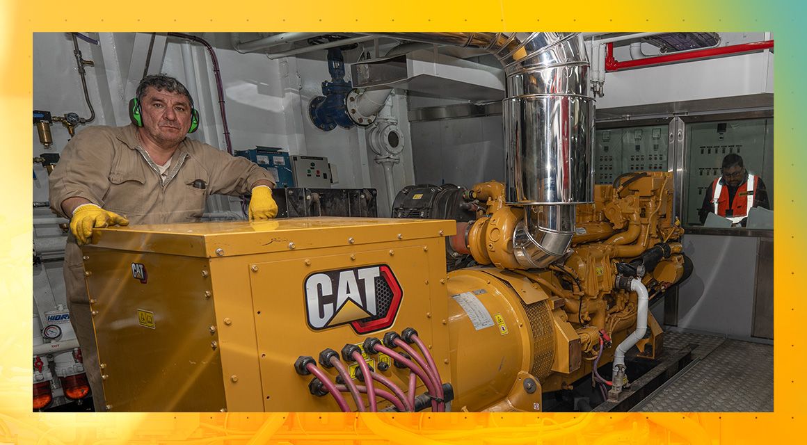 Man Standing Behind Cat Power Equipment