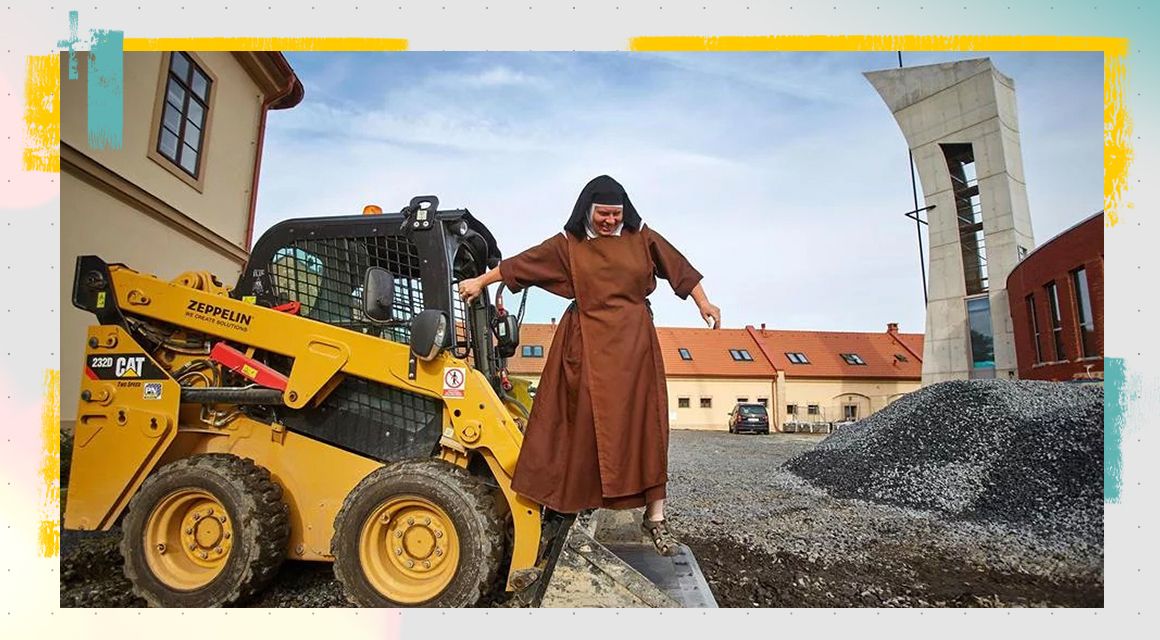 A nun stepping down from their skid steer loader